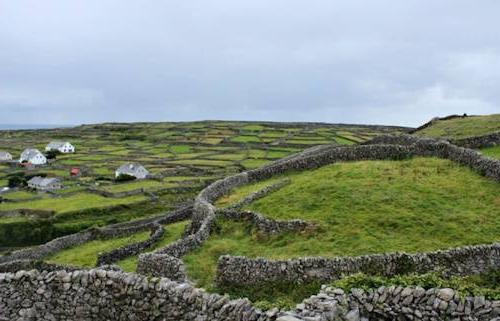 Green hills, farms, and cottages in County Kerry, Ireland.